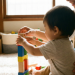 Toddler and parent playing with colorful wooden blocks on the floor, illustrating the use of fun educational toys for early childhood development.