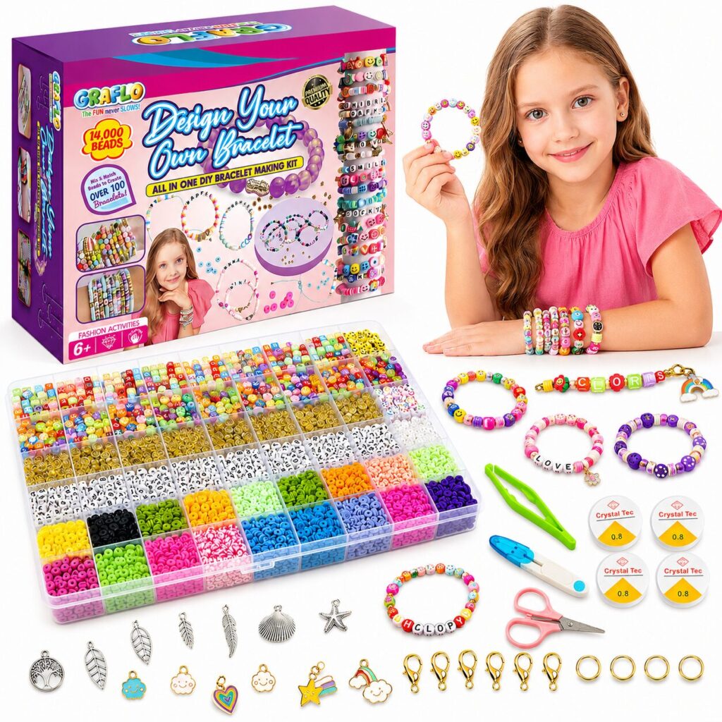 A girl holding a finished beaded bracelet beside the GRAFLO Design Your Own Bracelet box, with the 14,000 bead tray, charms, clasps, jump rings, elastic cords, scissors and tweezers laid out