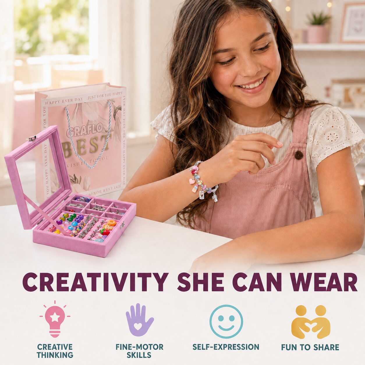 A girl wearing a finished charm bracelet beside the open GRAFLO jewellery box