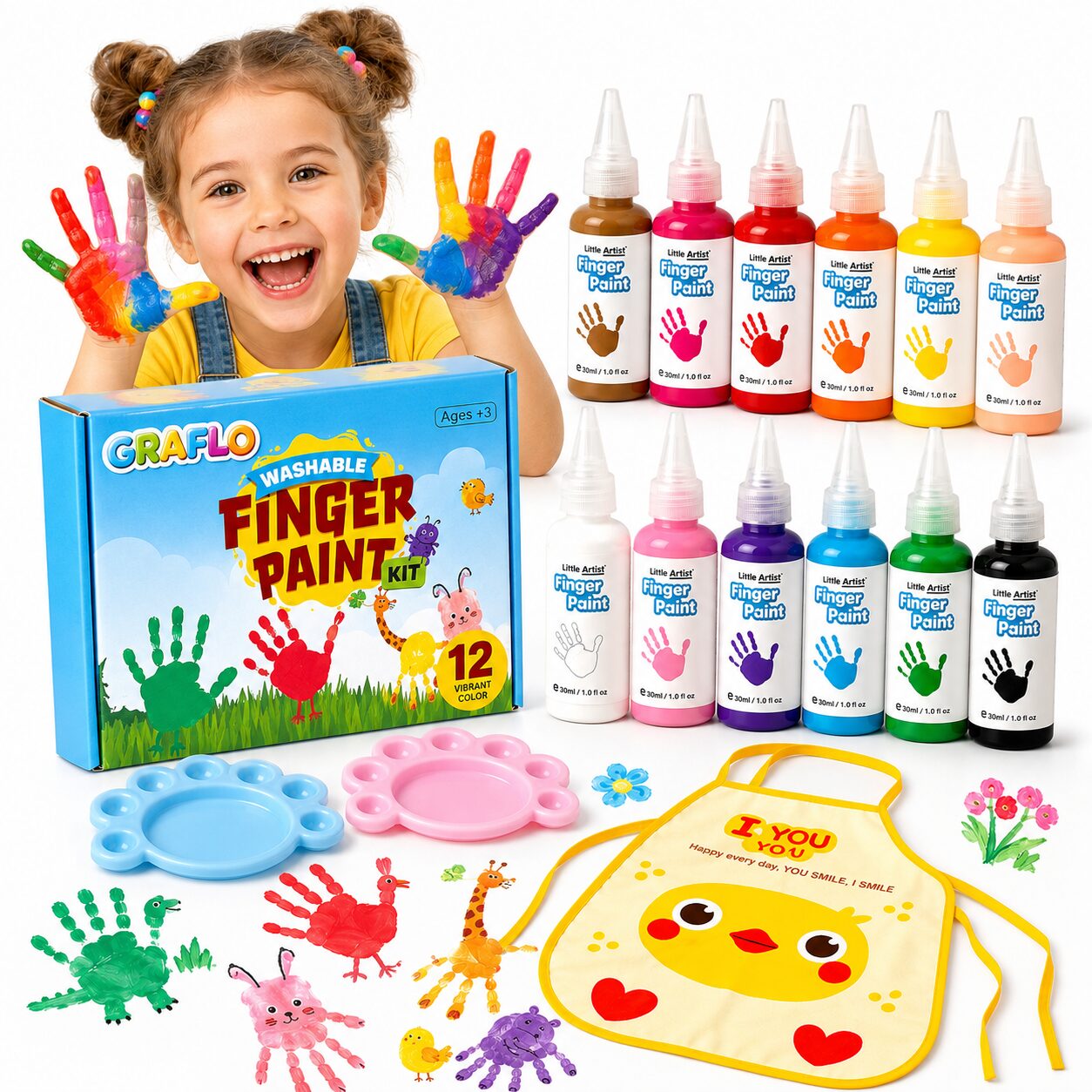 Smiling girl with paint-covered hands behind the GRAFLO washable finger paint box and all 12 colour bottles, with two paw-shaped palettes and a chick apron