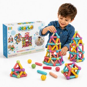 A boy building with GRAFLO magnetic sticks and balls beside the 60 piece box, with several completed shapes and loose sticks and balls on a white surface