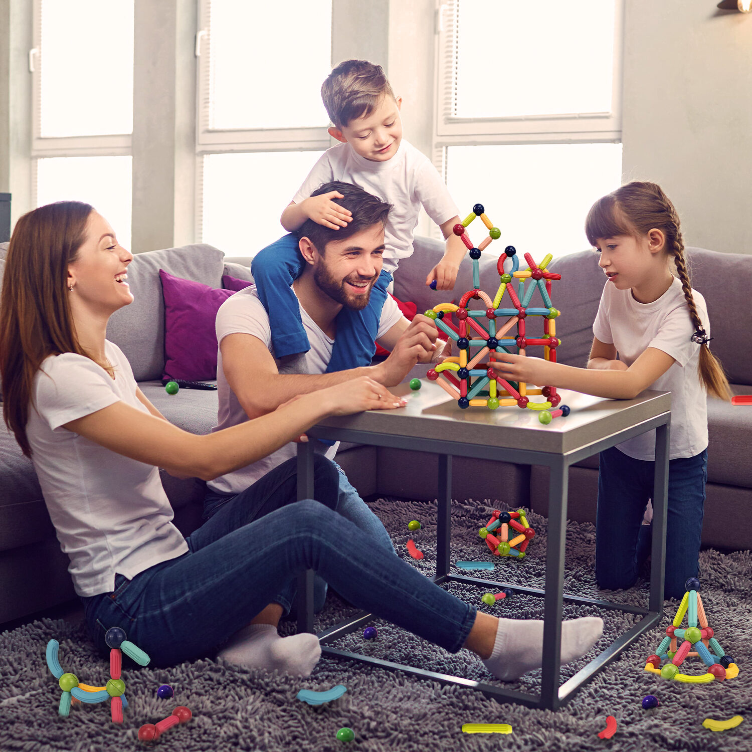 A family building with GRAFLO magnetic sticks and balls together at a living-room table