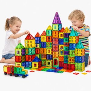 Two children building a large multi-coloured magnetic tile castle with towers and spires, with two magnetic tile cars in front Magnetic Building Tiles for Kids