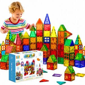 A child building a tall castle from the GRAFLO 110-piece magnetic tiles set, shown with the retail box and loose coloured tiles