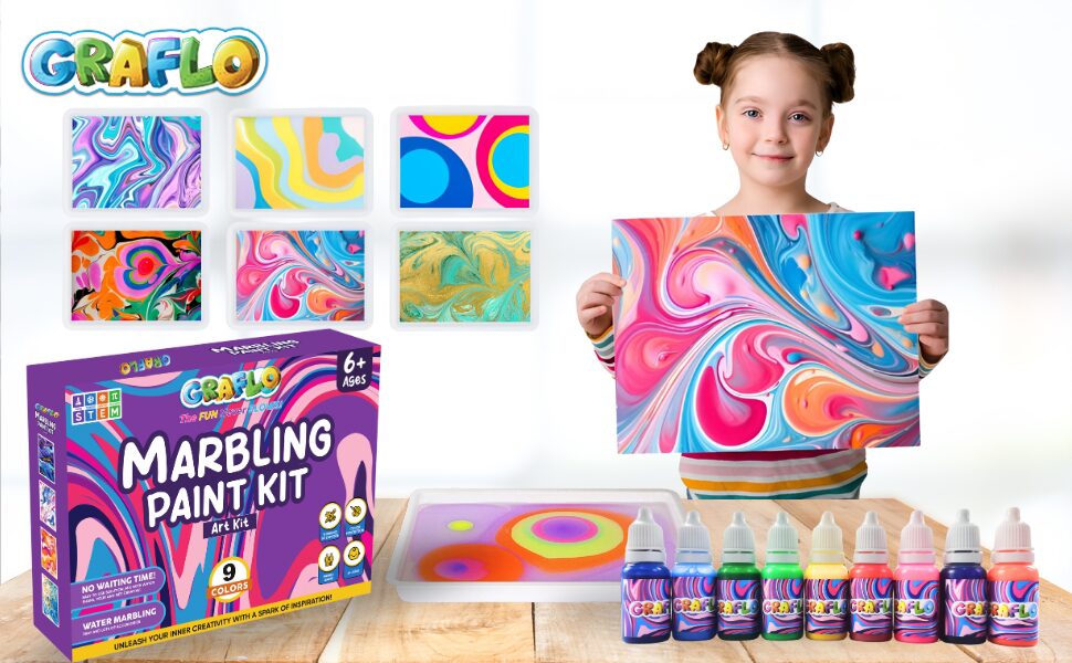 A girl holding a marbled print beside the GRAFLO Marbling Paint Kit box, pigment bottles and six sample patterns