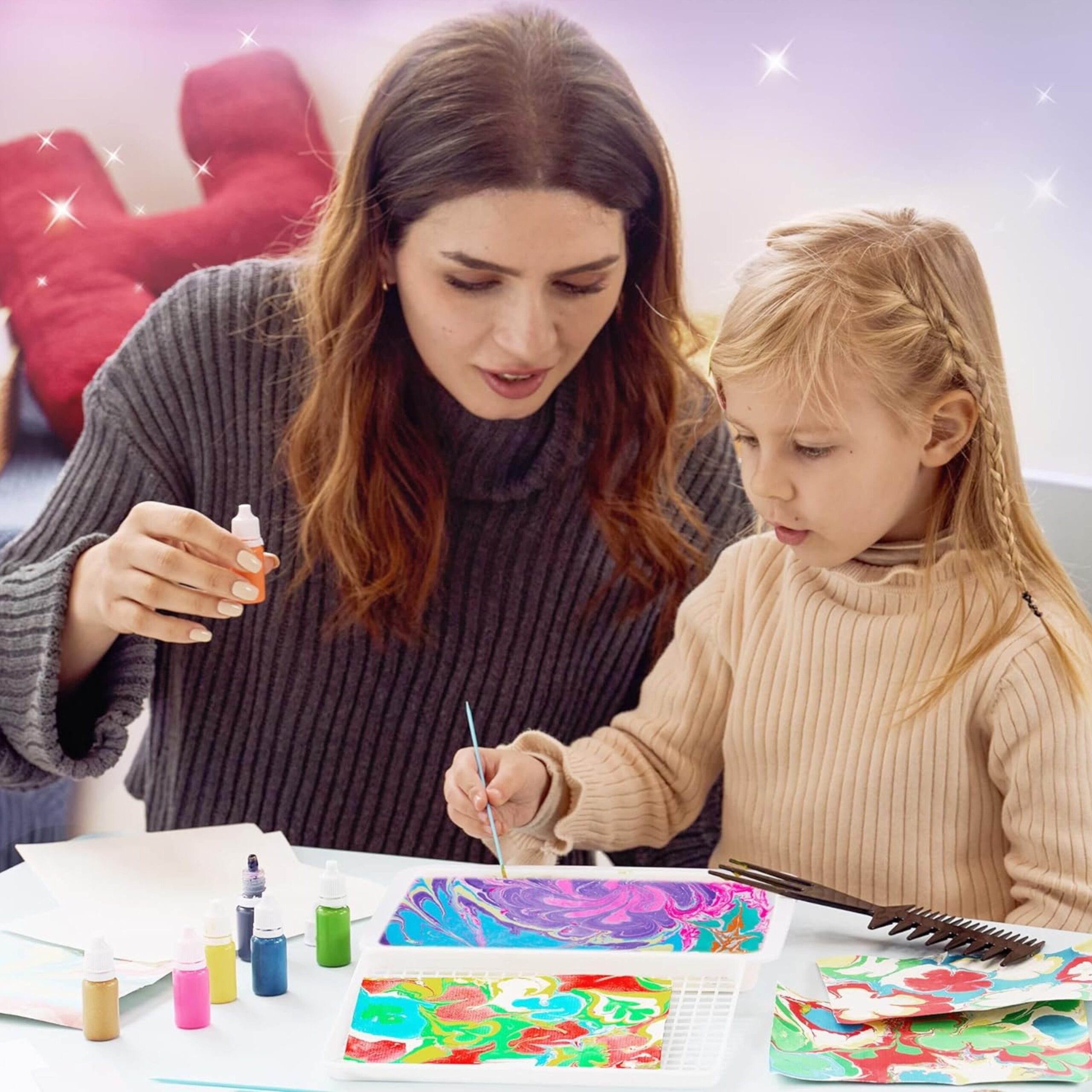 A mother and daughter marbling prints together at a table with the GRAFLO kit