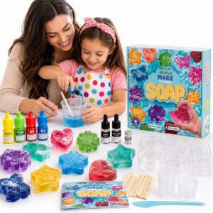 Mother and daughter mixing blue soap in a cup beside the GRAFLO Make Your Own Soap box, with four colorants, two fragrances, glitter, moulds, a how-to book, mixing cups and wooden sticks laid out