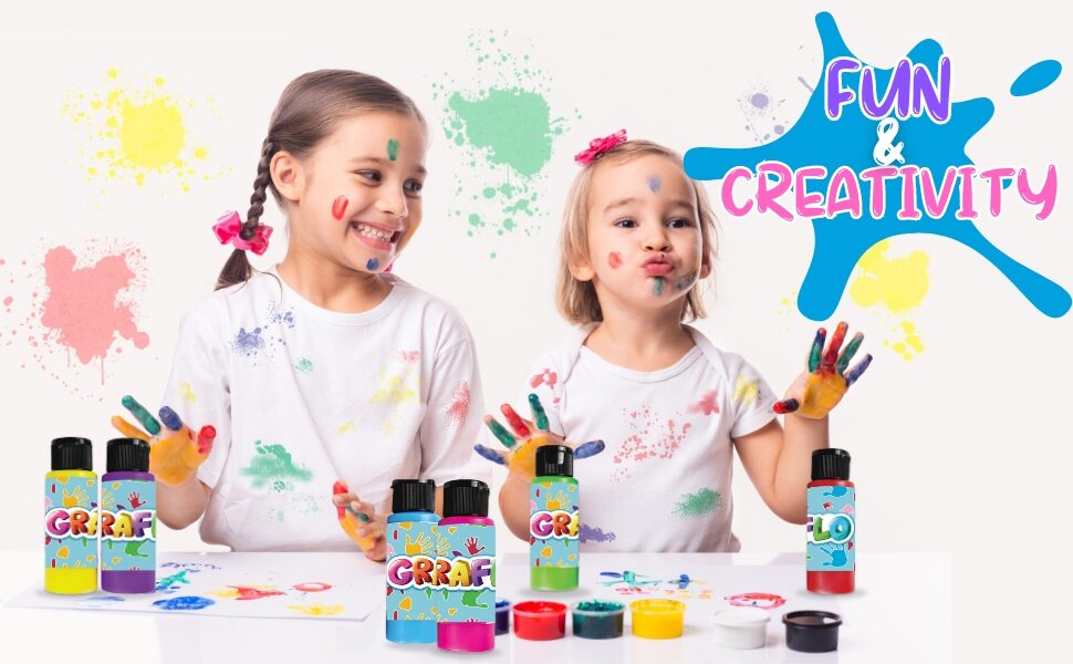 Fun and creativity: two girls with paint on their hands and faces beside the paint bottles